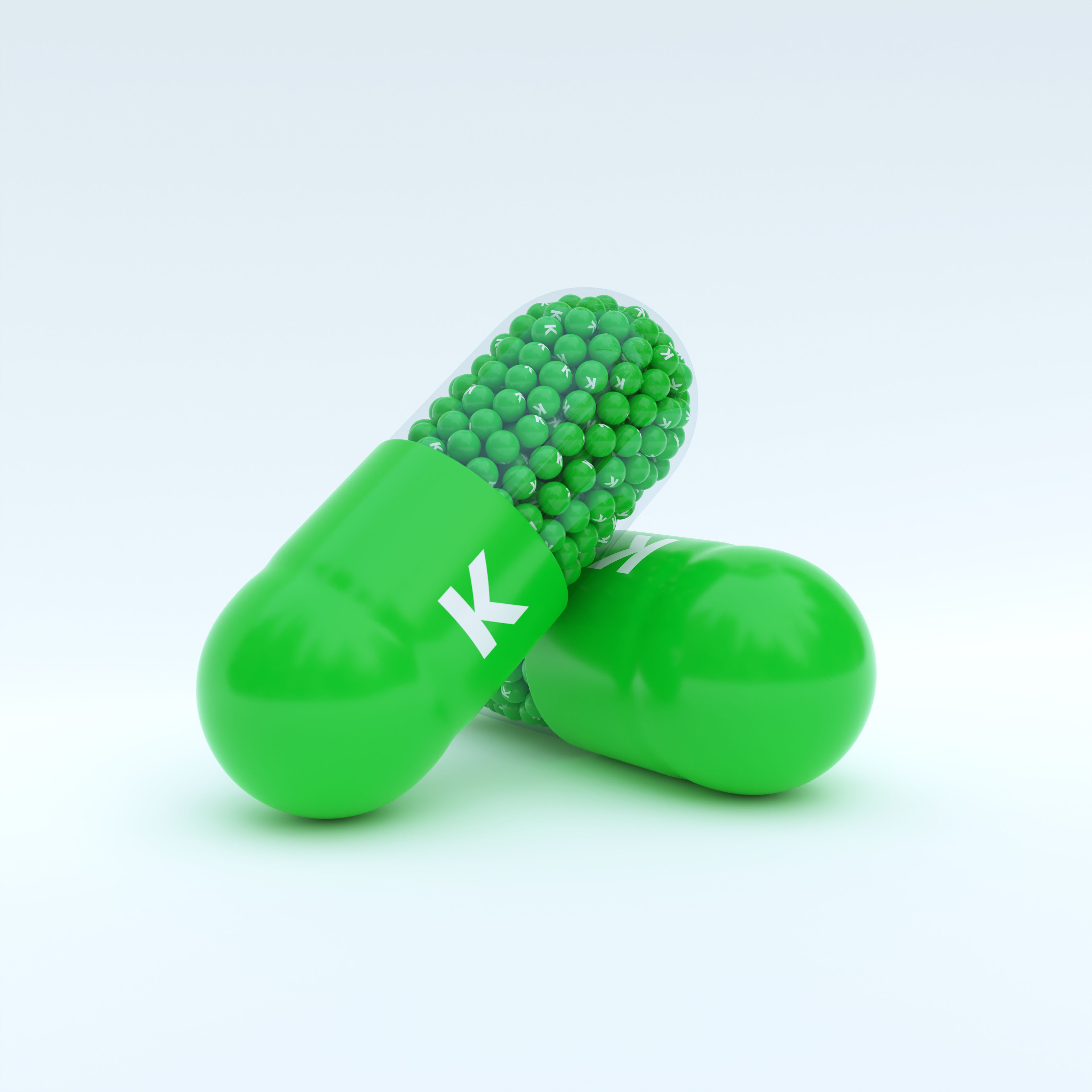 Vitamin K With Green Capsule, Granules and White Background
