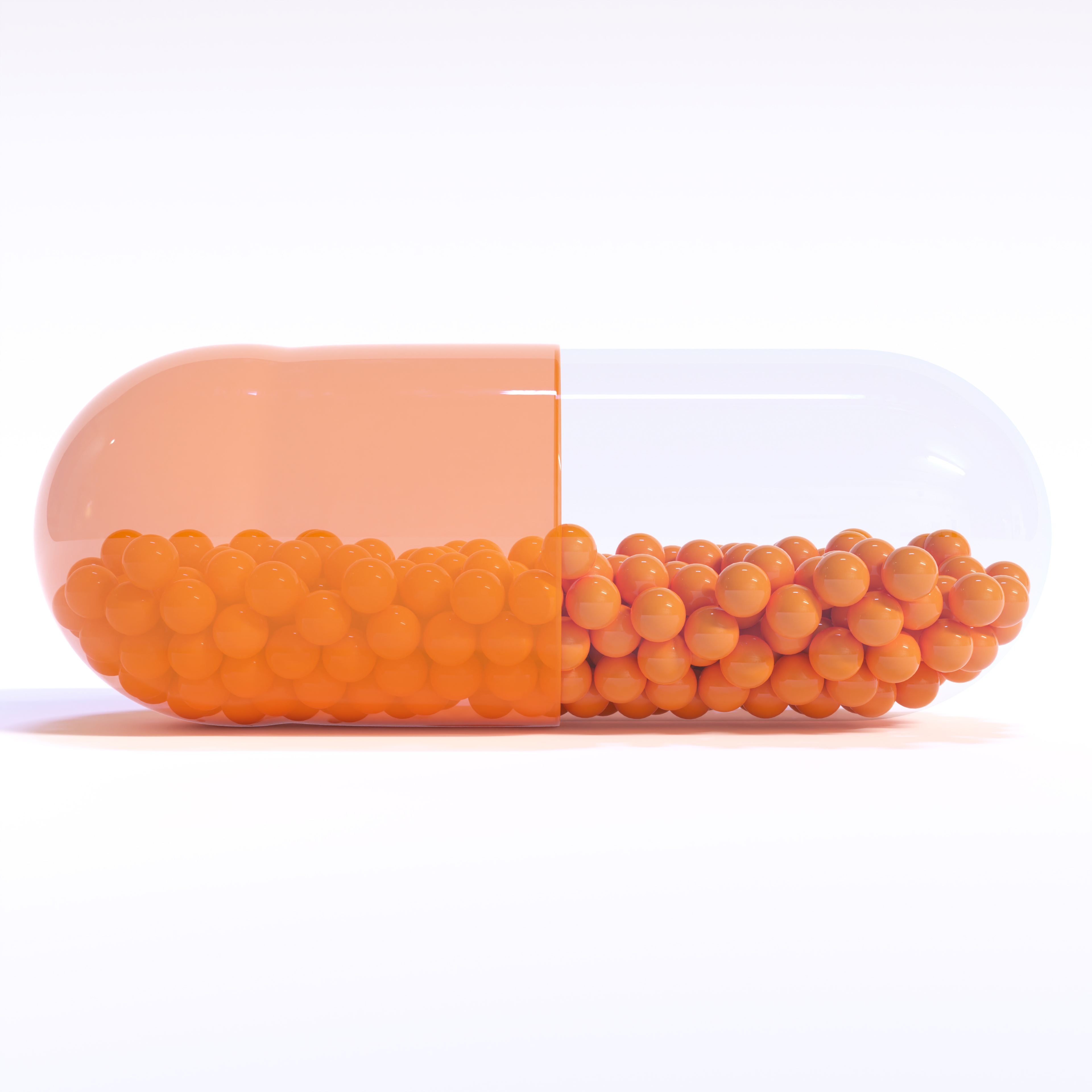Transparent Orange Capsule With Granules With White Background