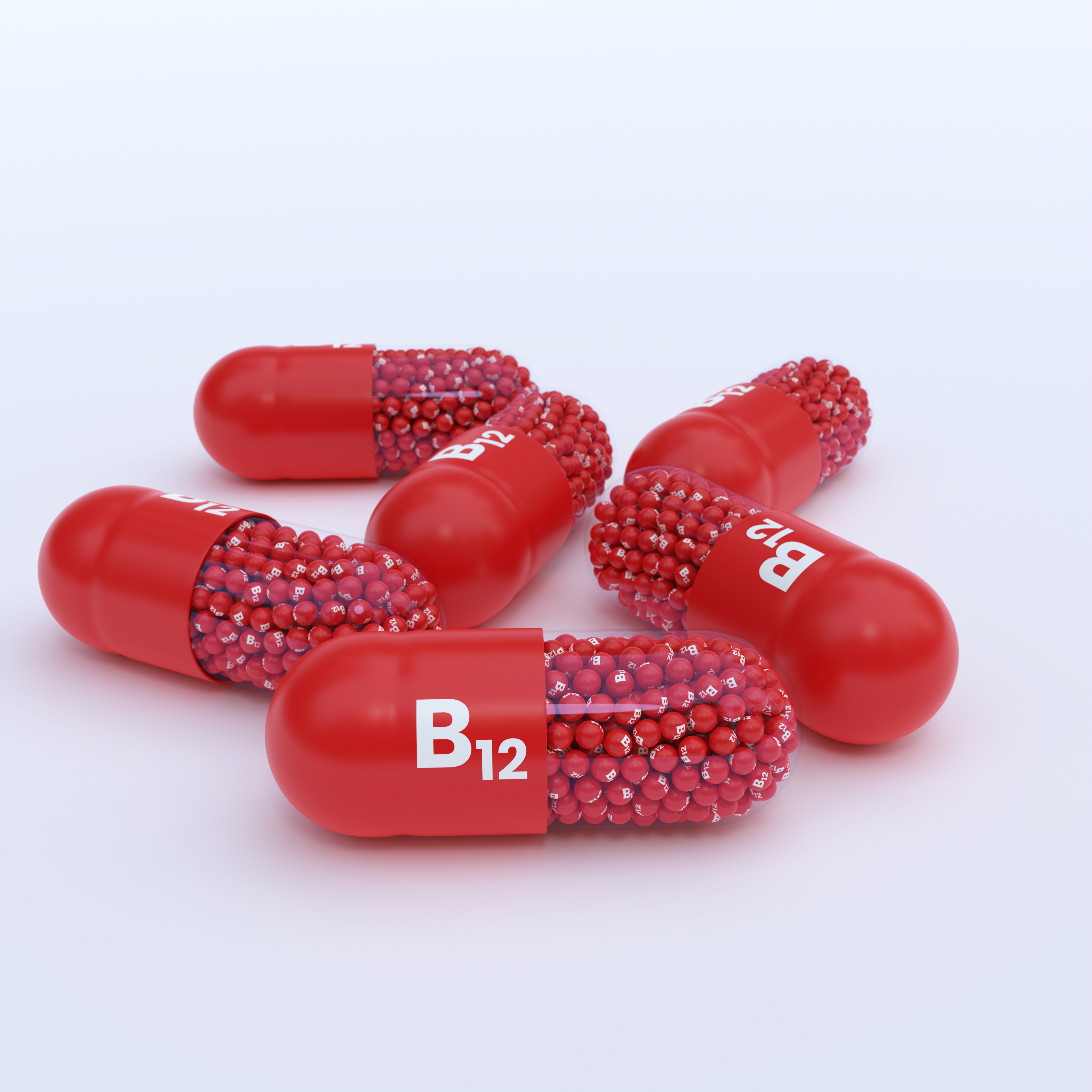 Vitamin B12 With Red Capsules, Granules and White Background