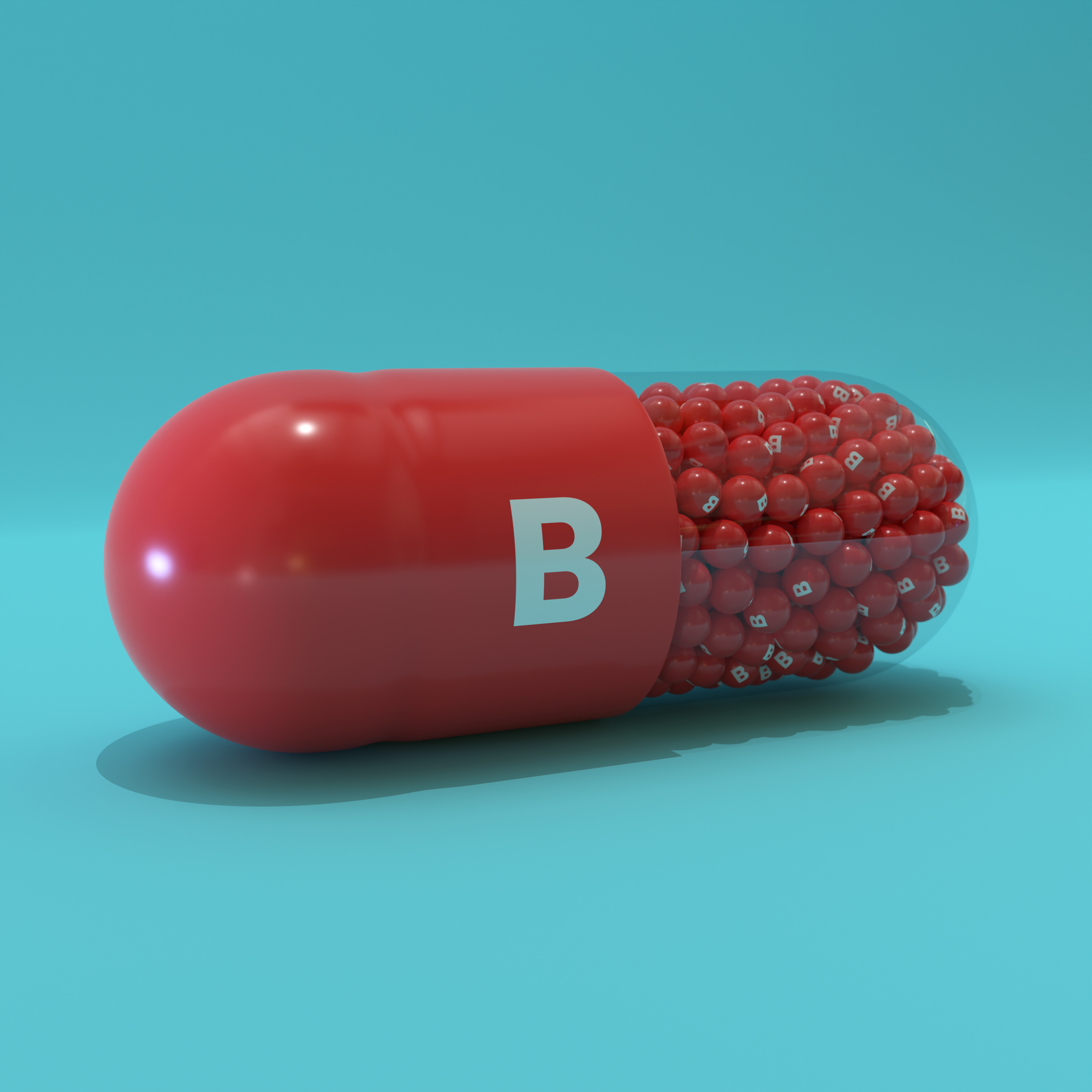 Vitamin B With Red Capsule, Granules and Turqoise Background