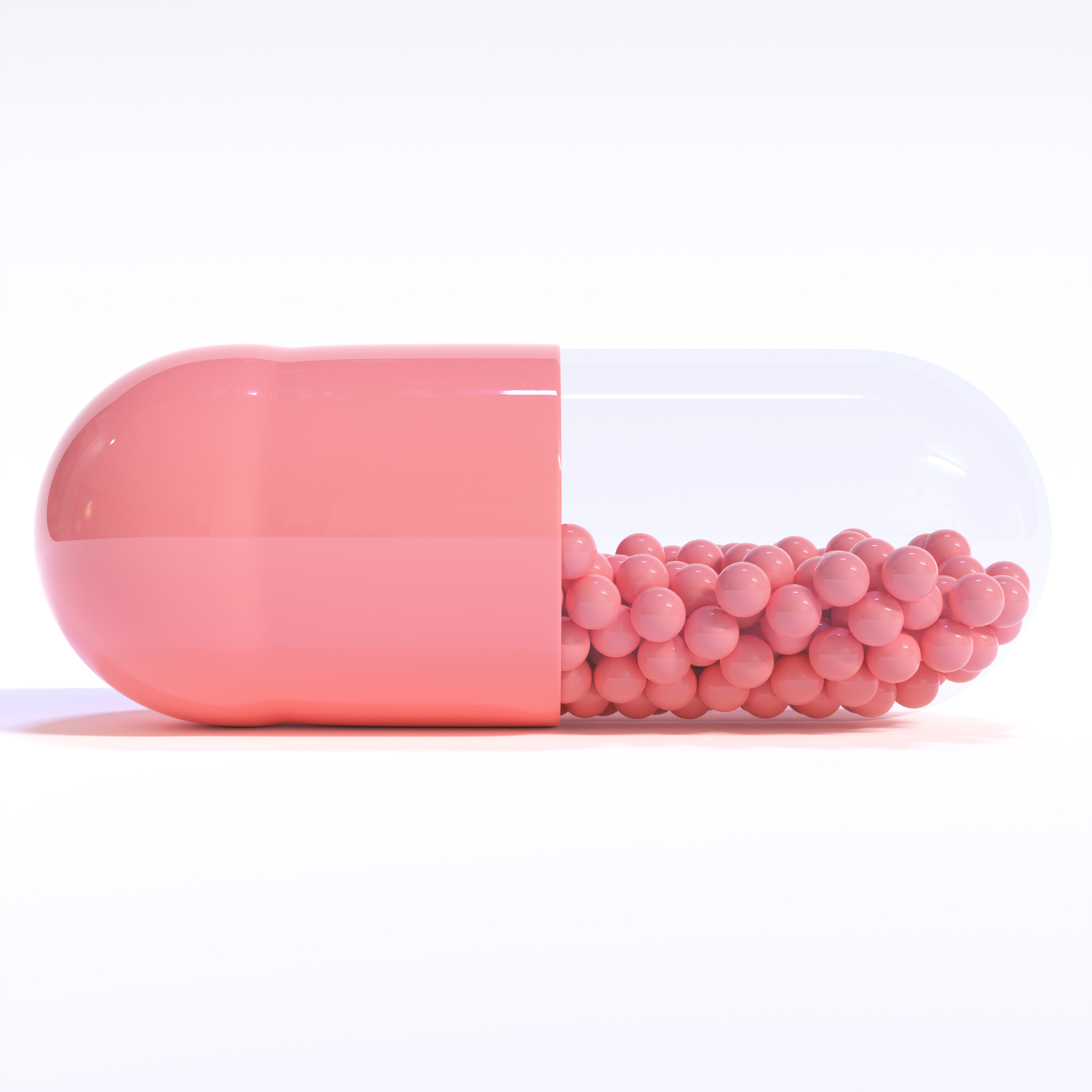 Pink Capsule Full of Granules On White Background