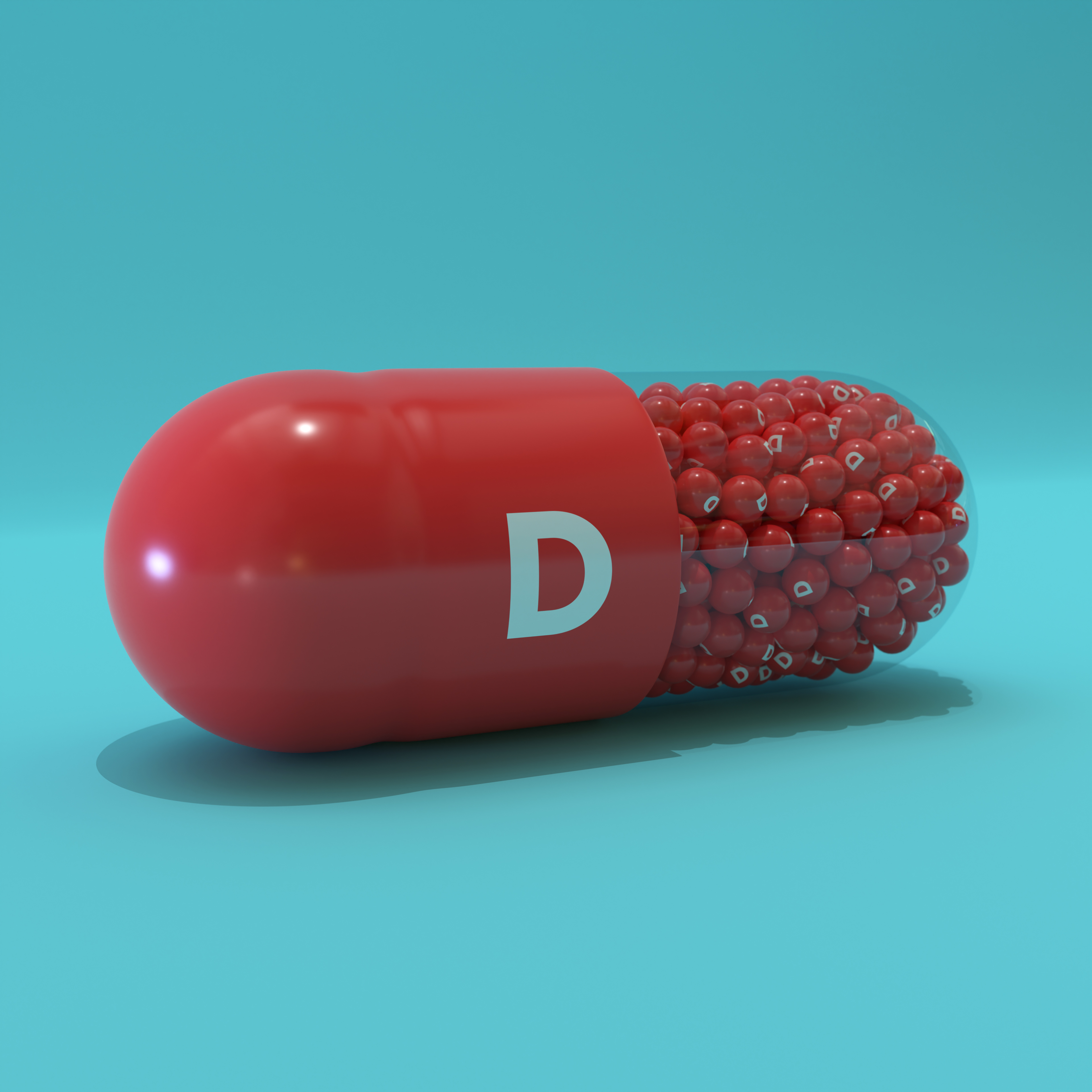 Vitamin D With Red Capsule, Granules and Turqoise Background