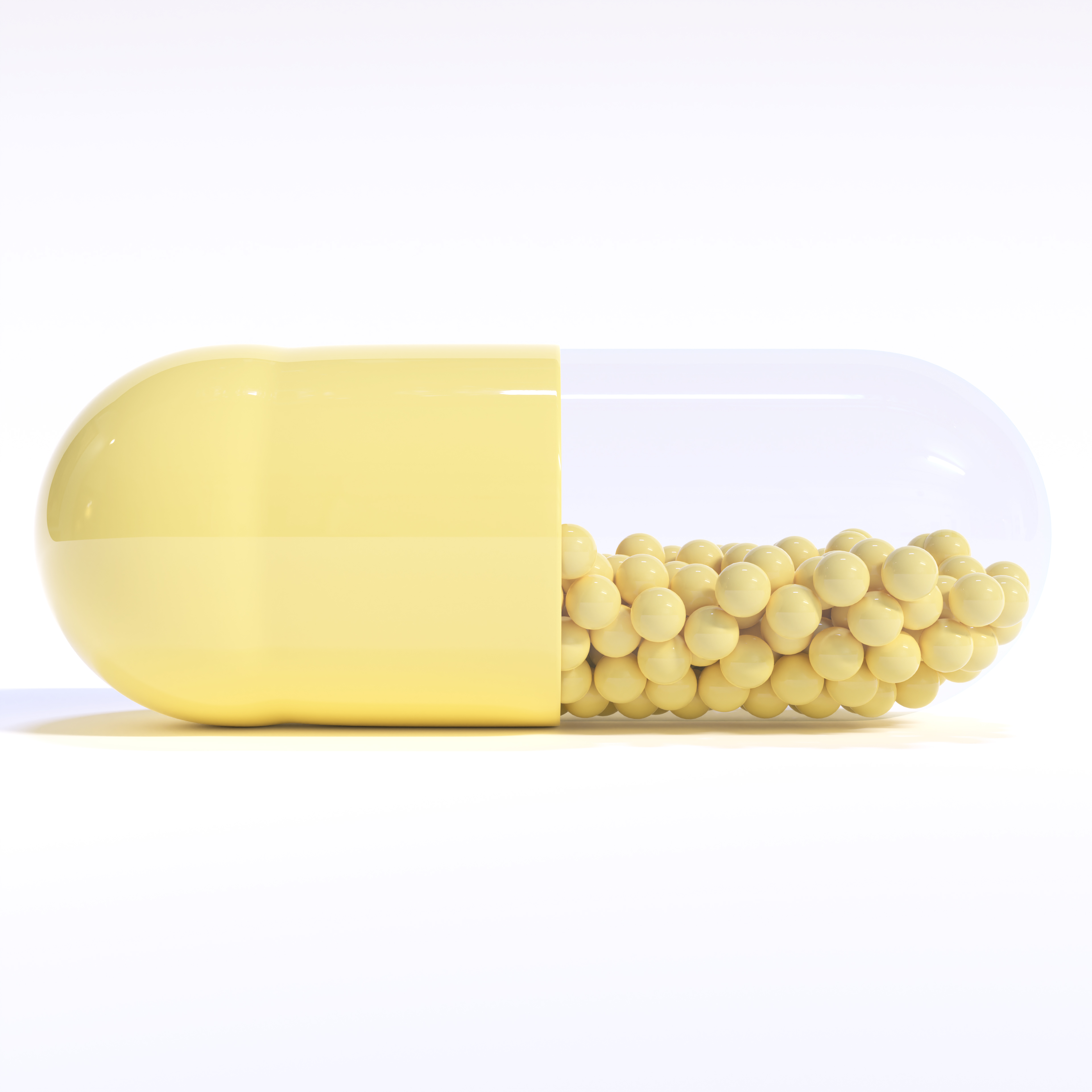 Yellow Capsule Full of Granules On White Background