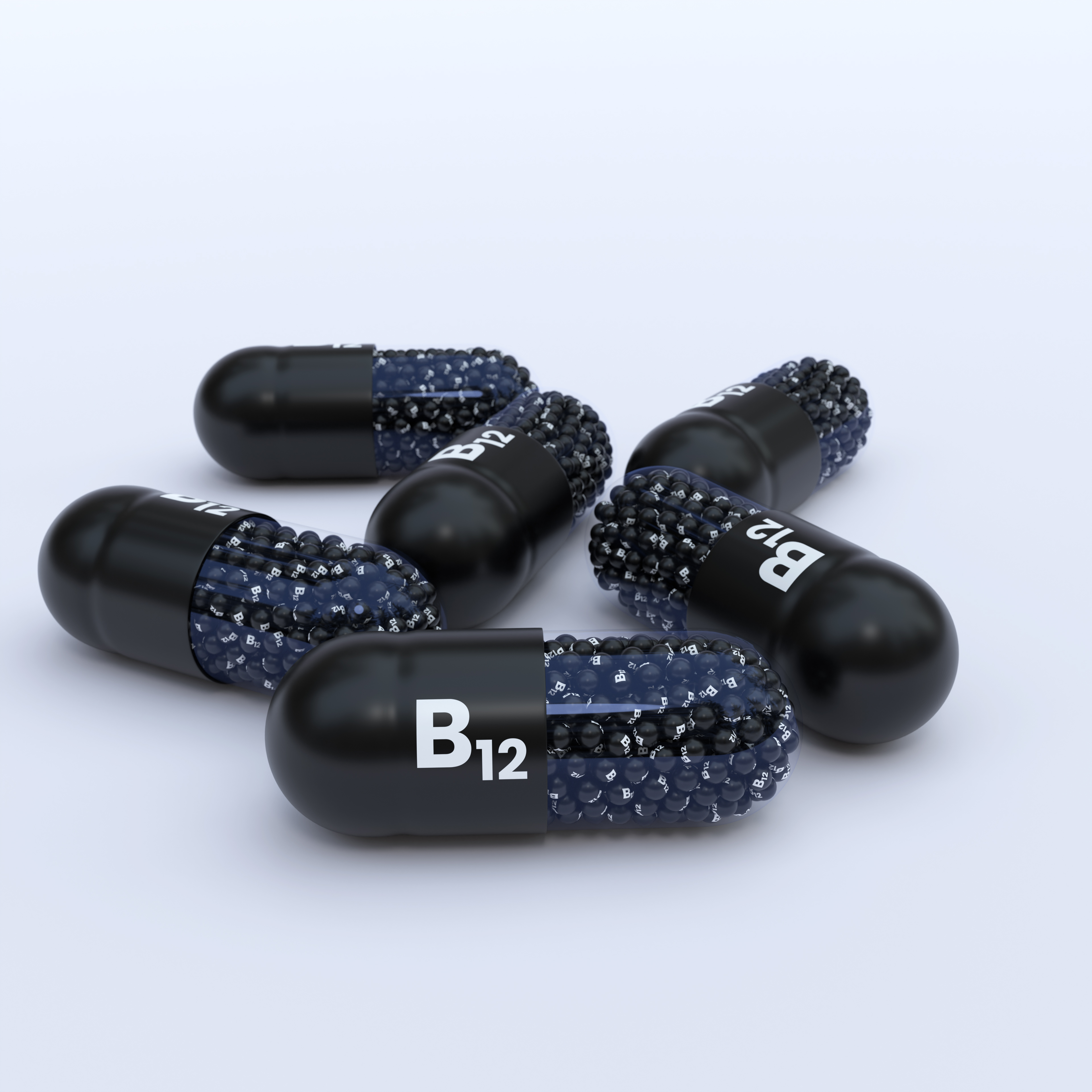 Vitamin B12 With Black Capsules, Granules and White Background