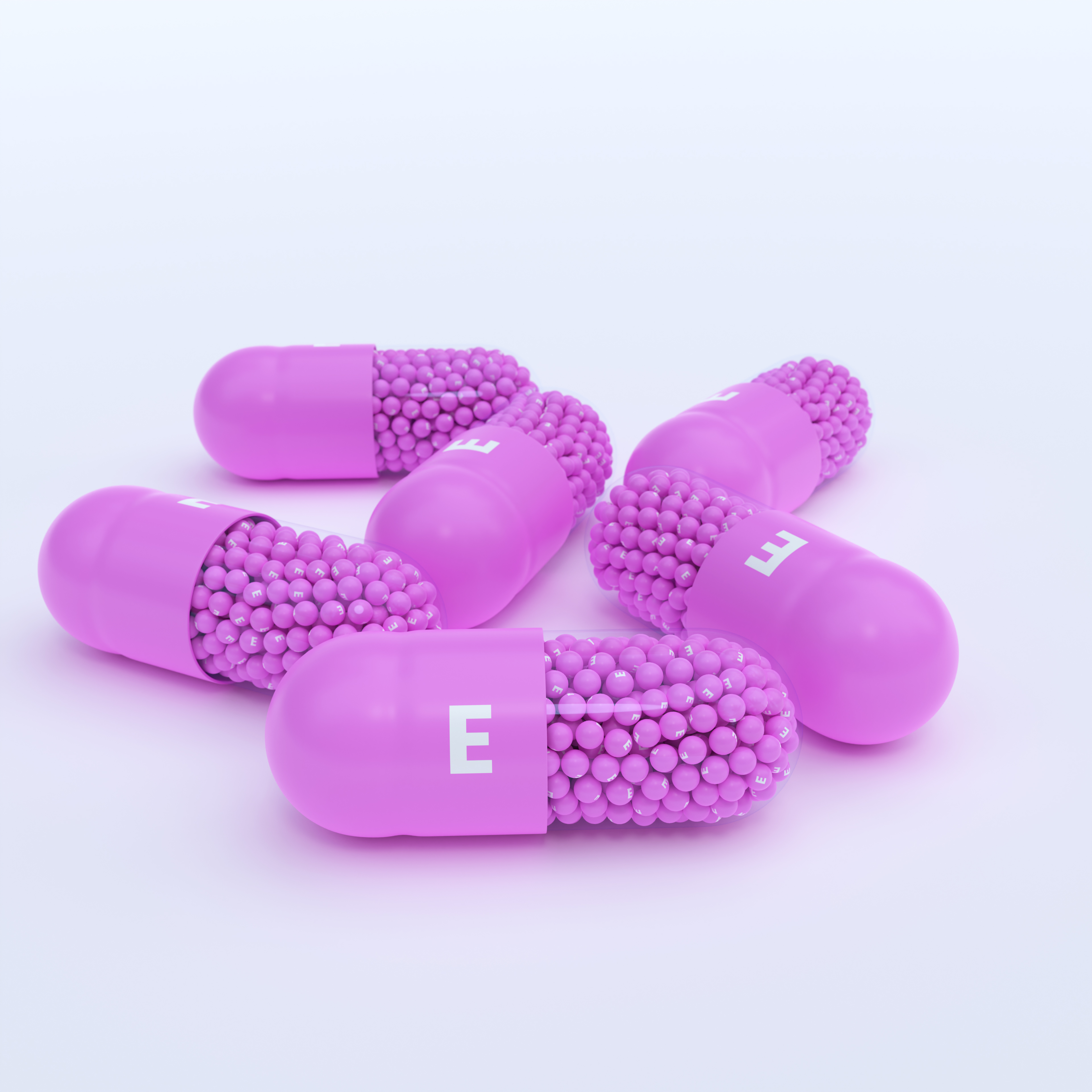 Vitamin E With Pink Capsules, Granules and White Background