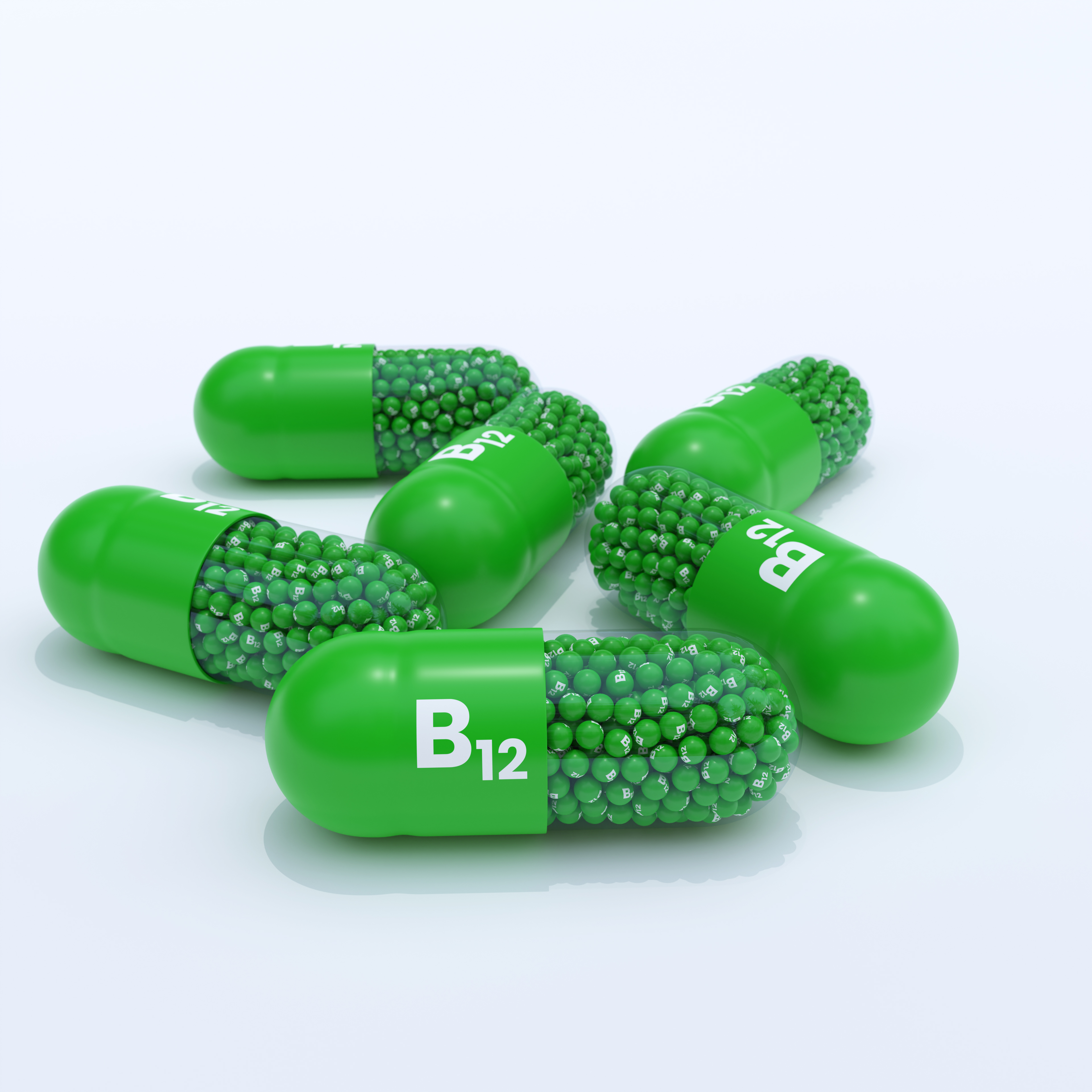 Vitamin B12 With Green Capsules, Granules and White Background