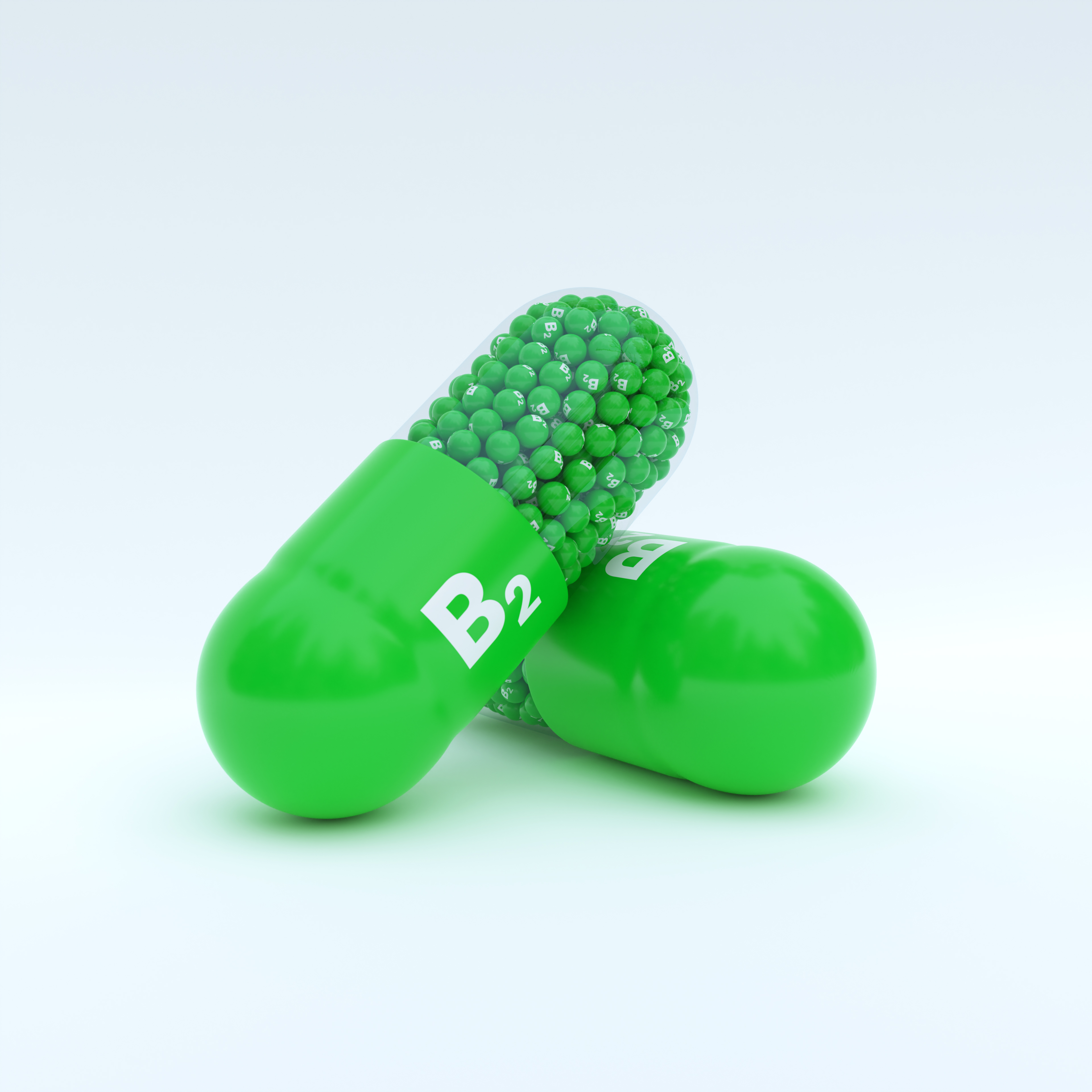 Vitamin B2 With Green Capsule, Granules and White Background