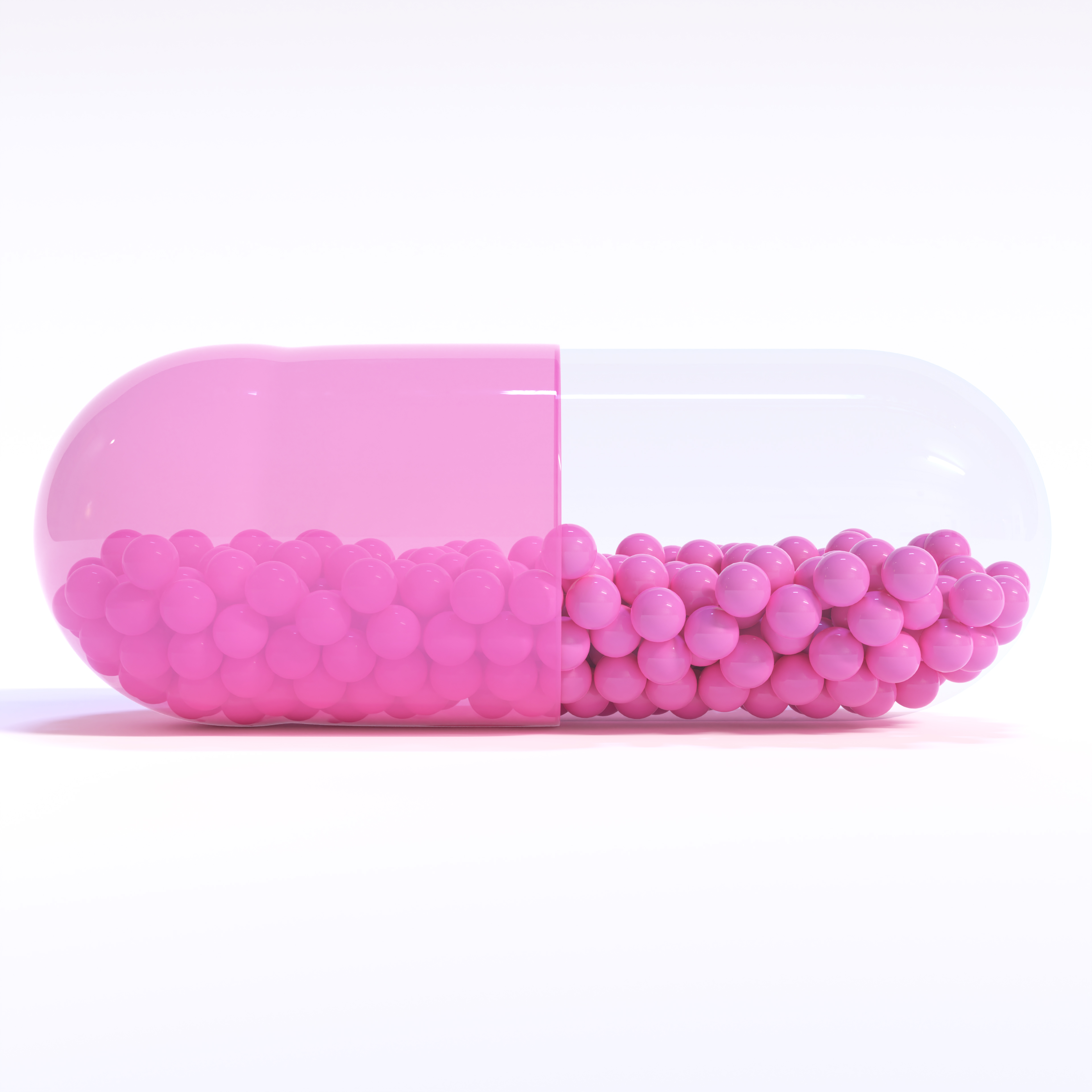 Transparent Pink Capsule With Granules With White Background