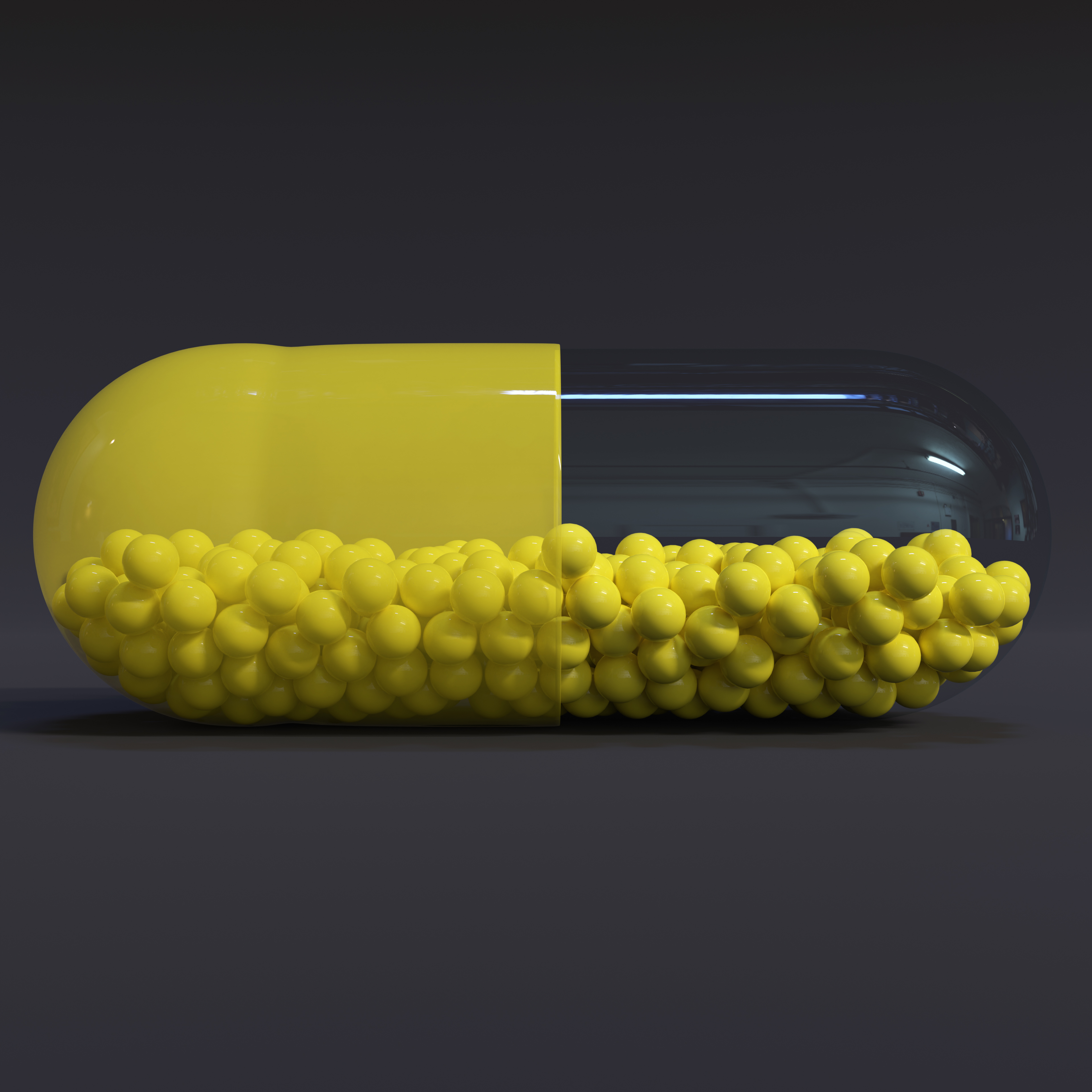 Transparent Yellow Capsule With Granules With Dark Background