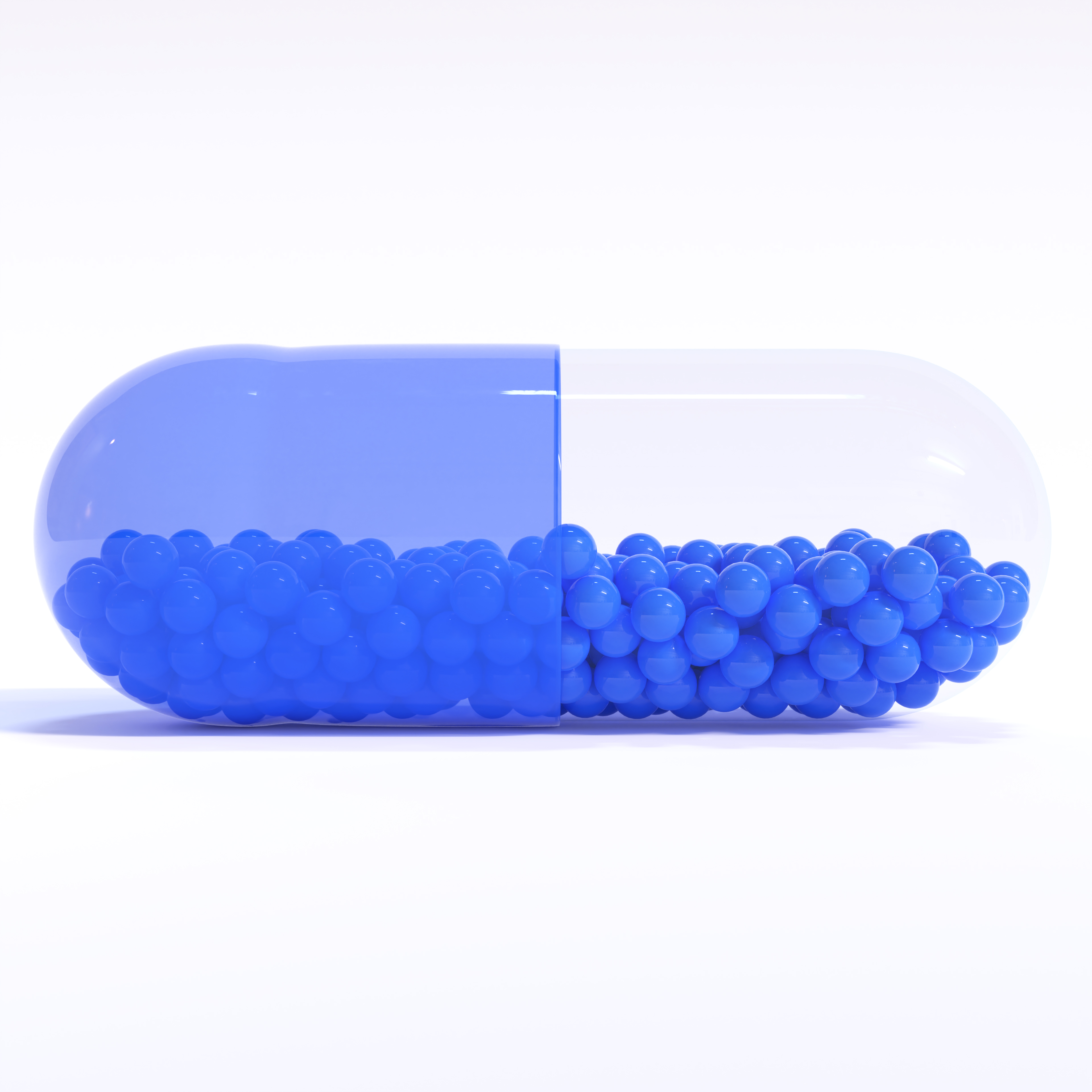 Transparent Blue Capsule With Granules With White Background