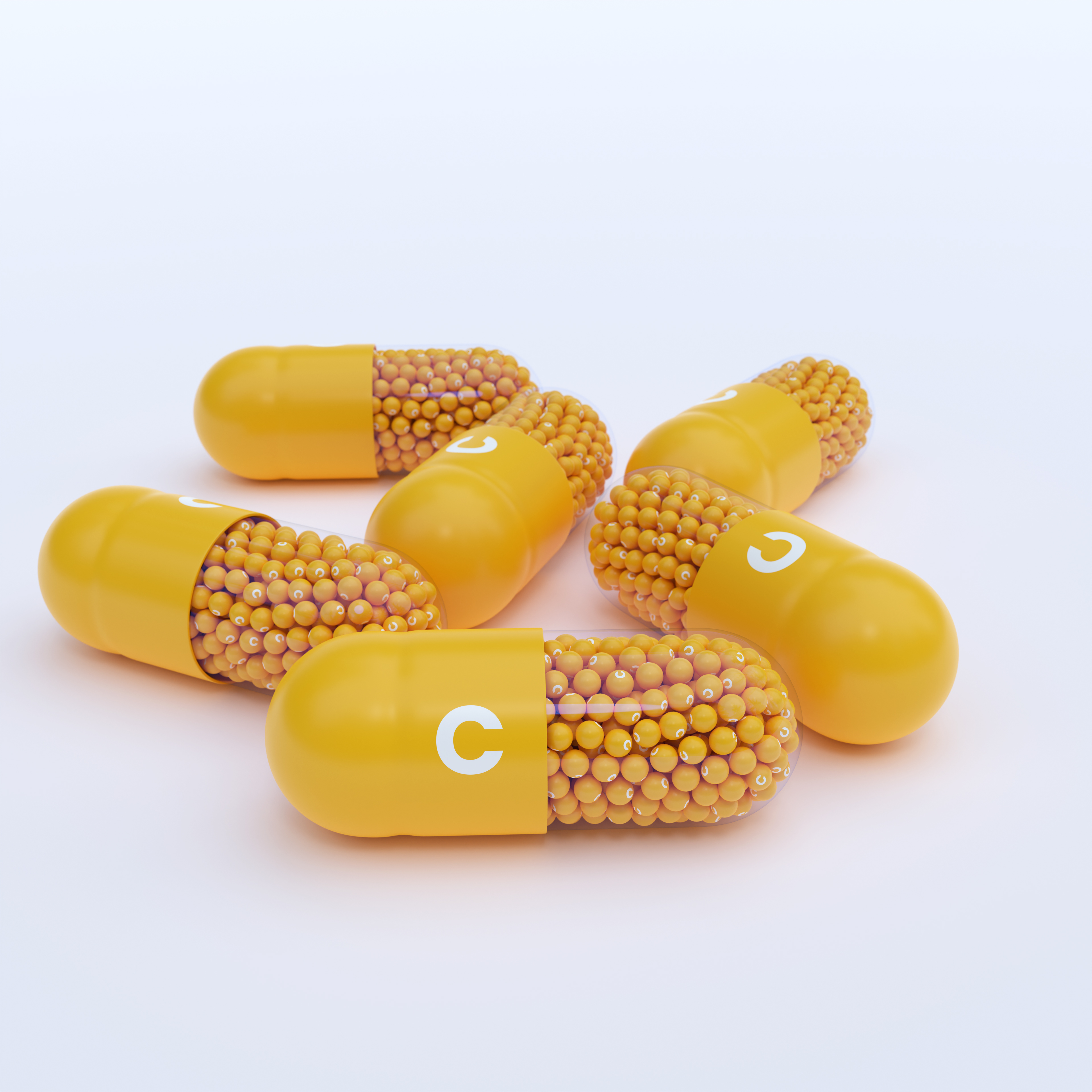 Vitamin C With Yellow Capsules, Granules and White Background