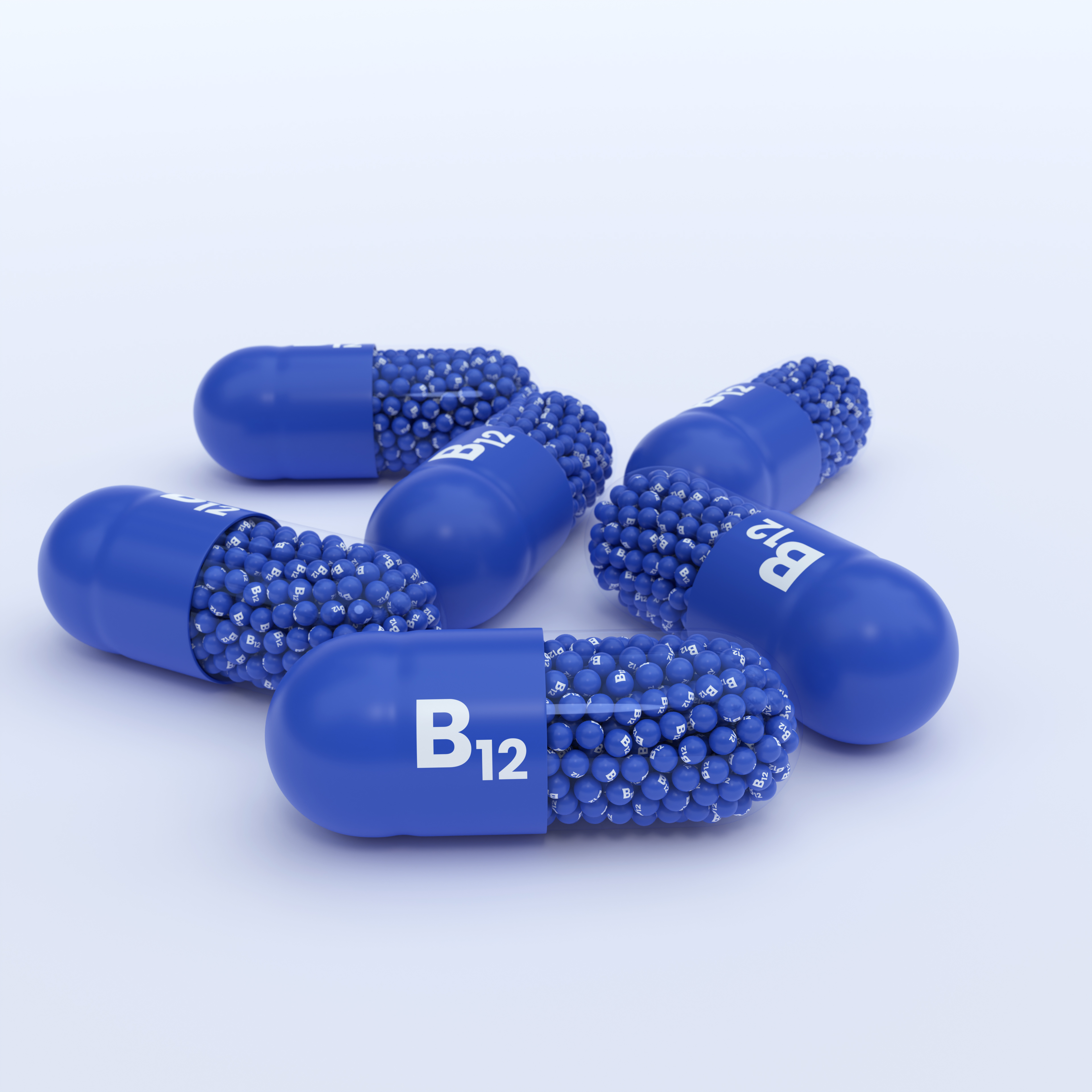 Vitamin B12, Blue Capsules, Granules and Whtie Background