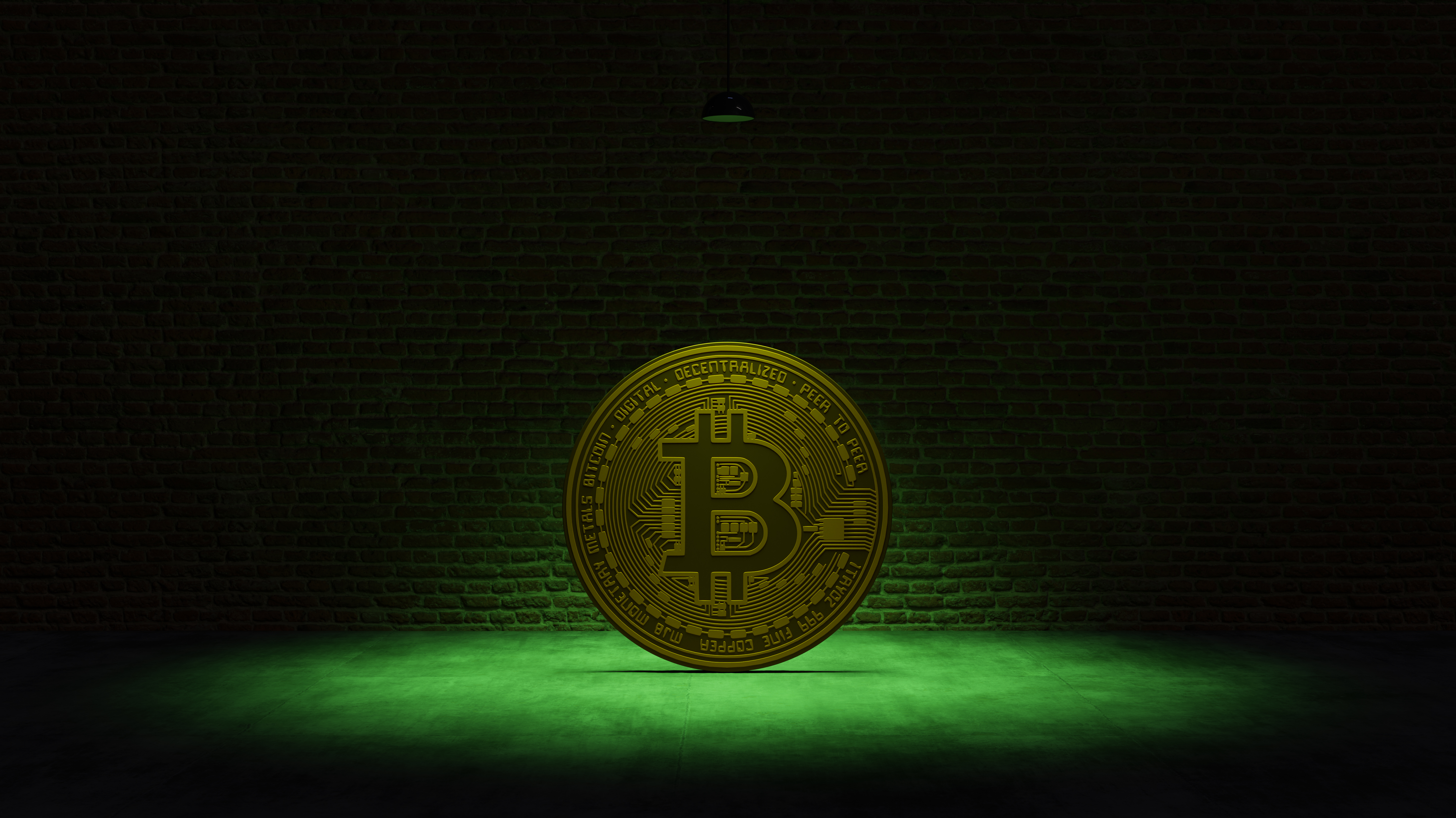 Golden Bitcoin under a green spotlight in front of a brick wall