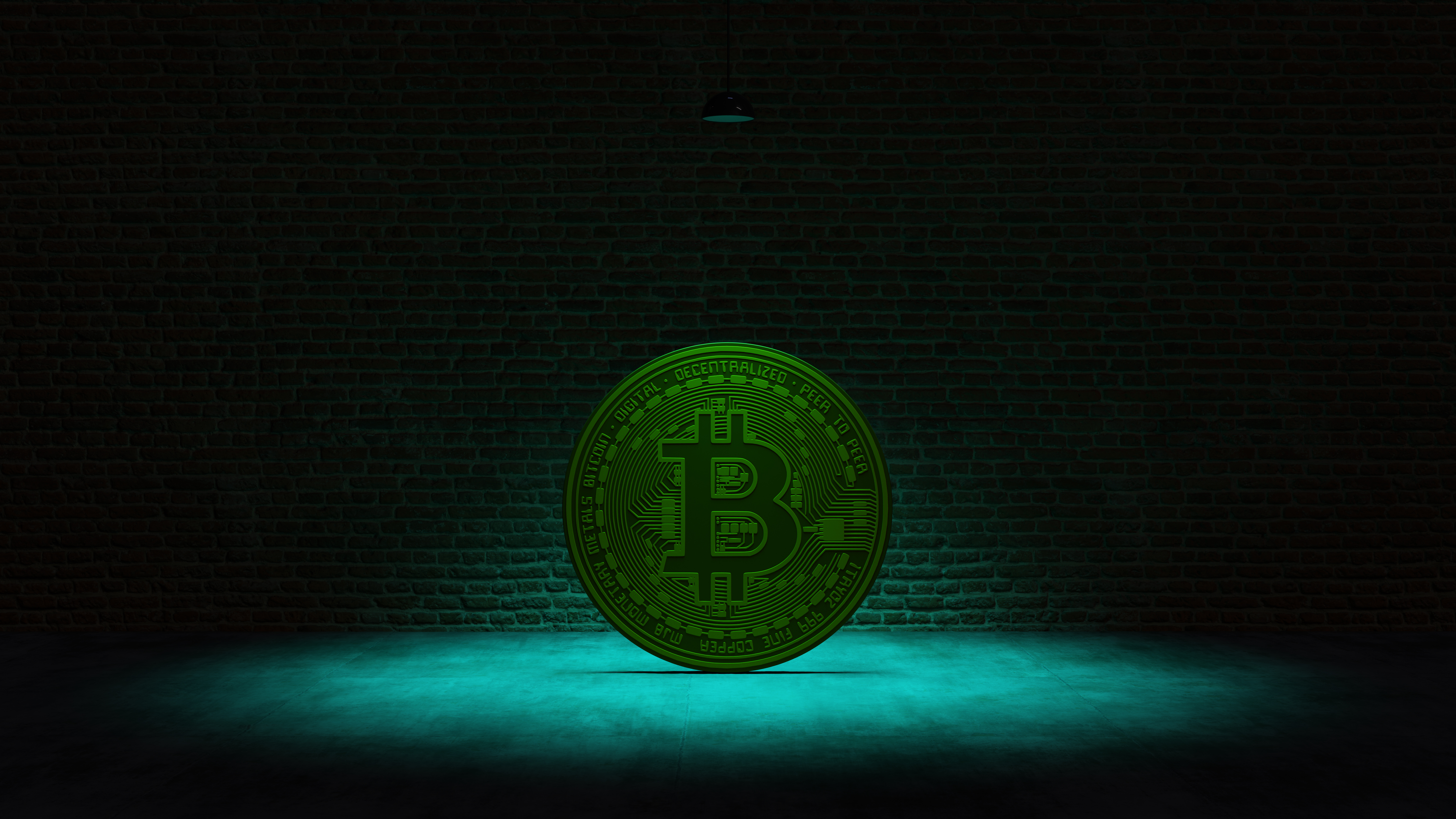 Golden Bitcoin under a turquoise spotlight in front of a brick wall