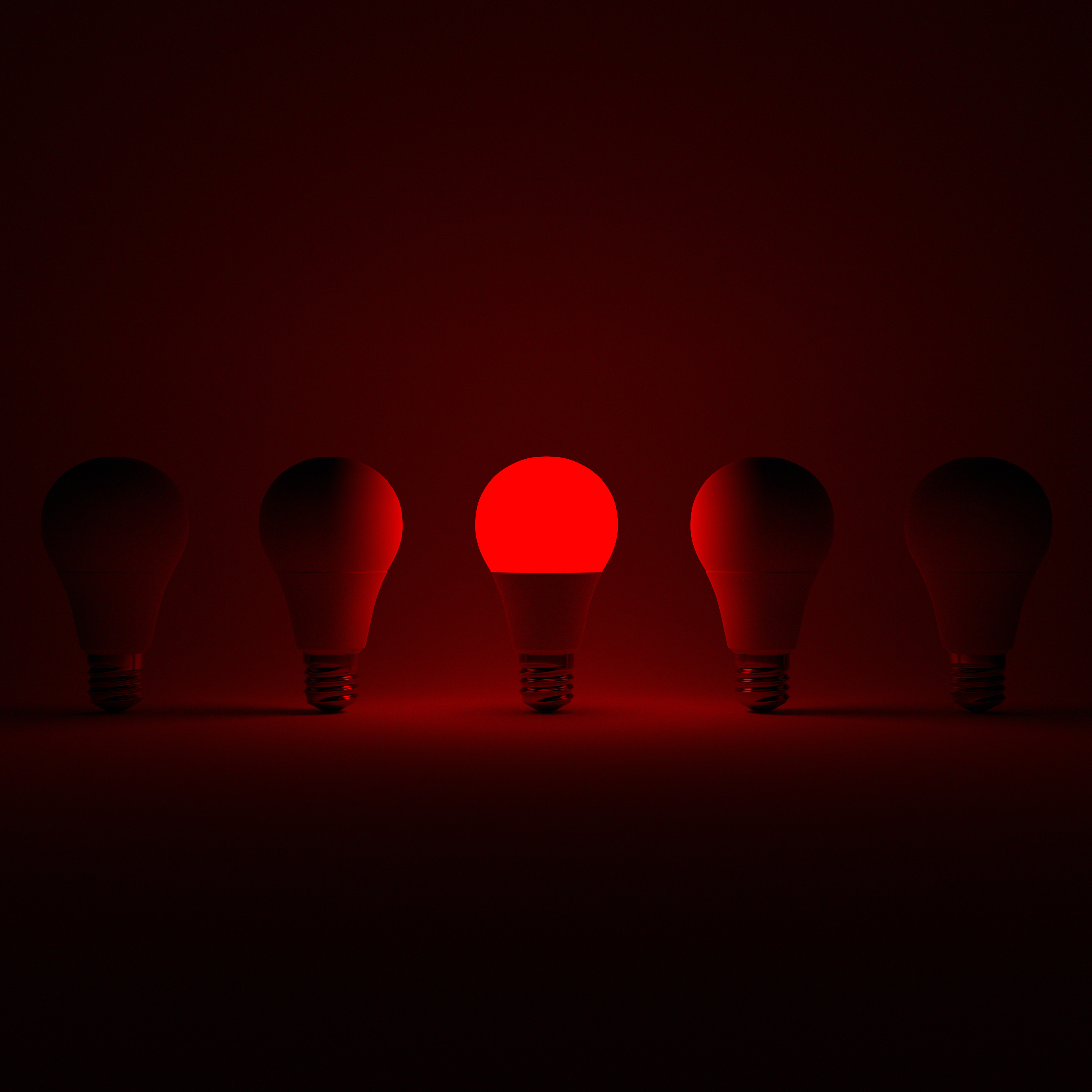 Five Lightbulb and One Glowing Red Lightbulb with White Background