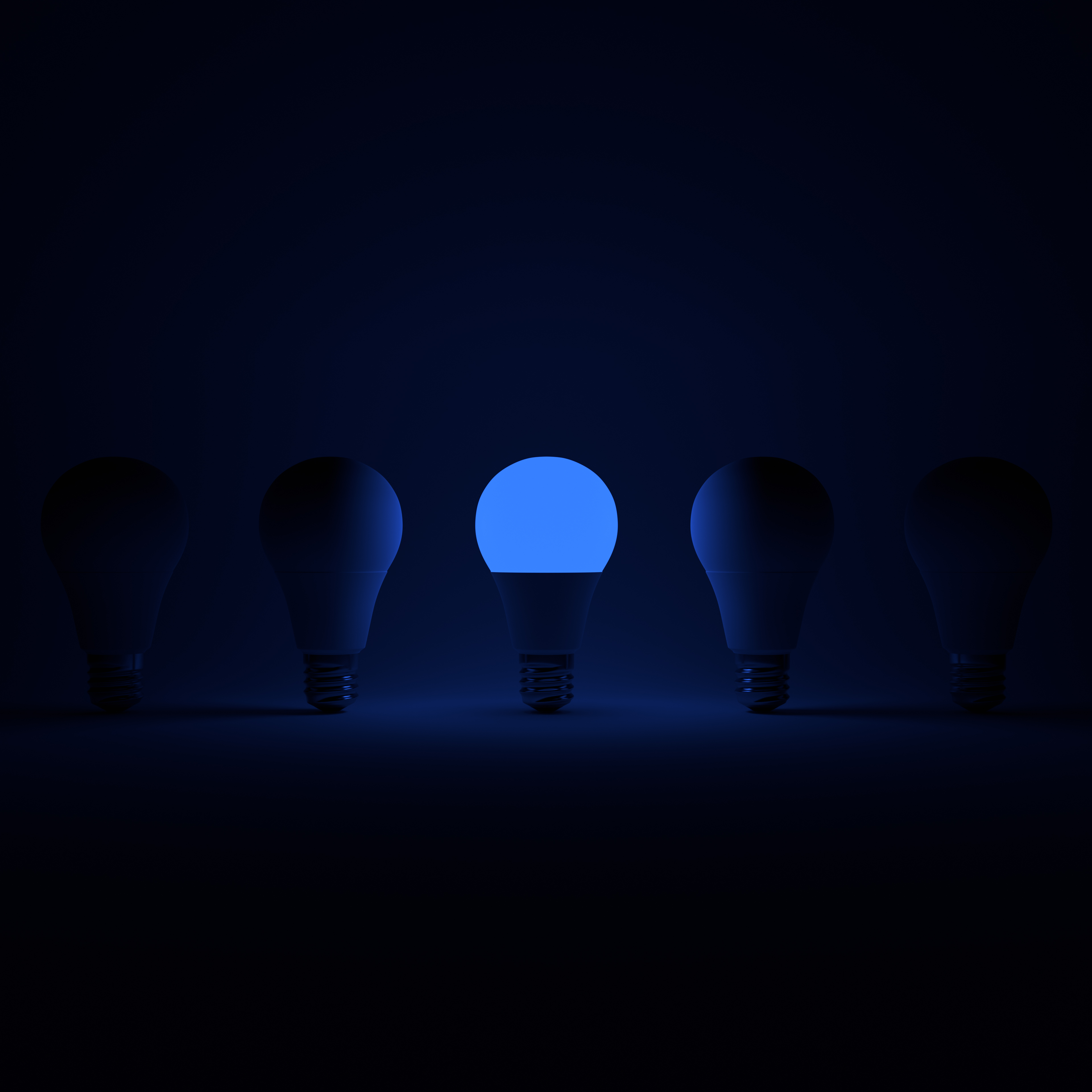 Five Lightbulb and One Glowing Blue Lightbulb with White Background