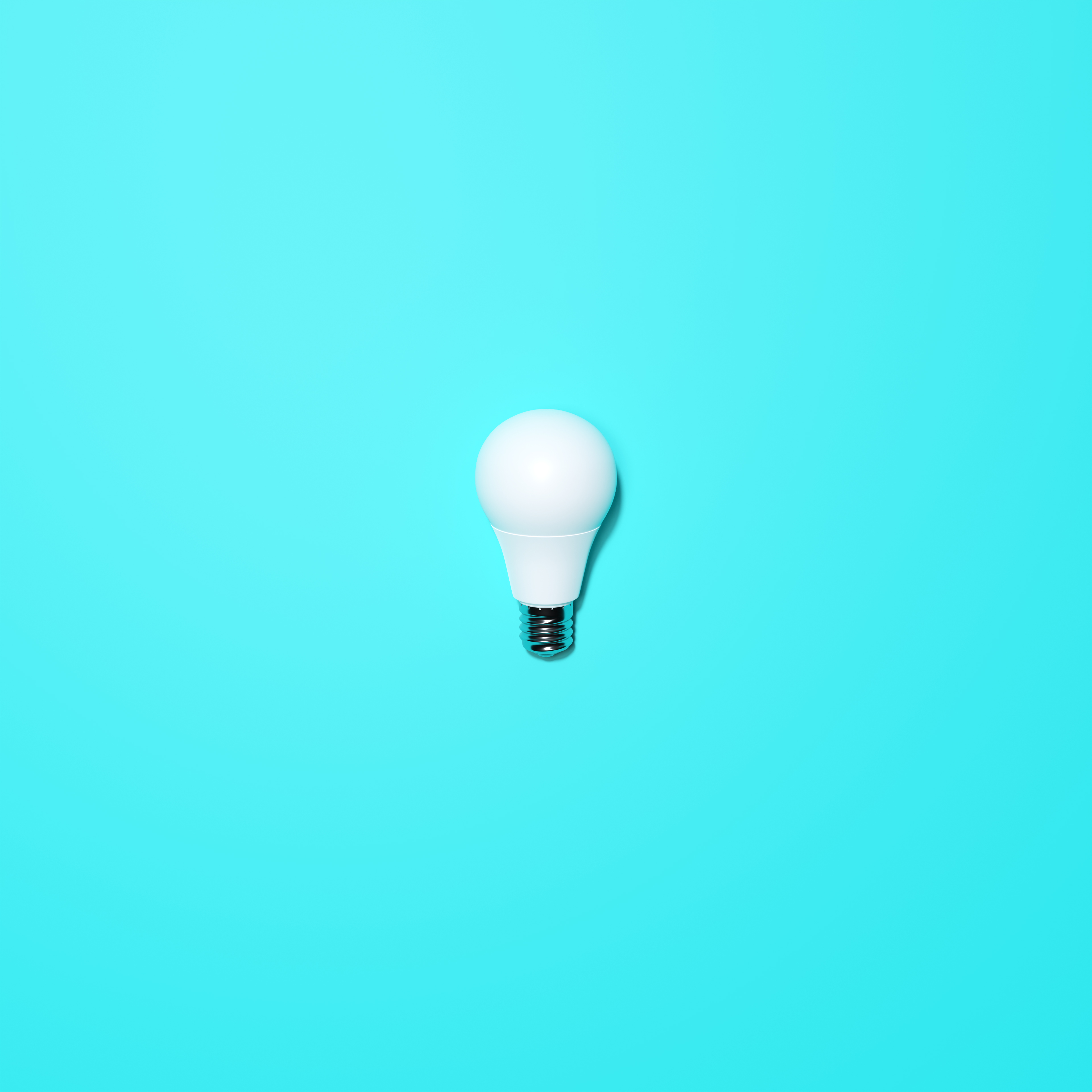 White Lightbulb With Turqoise Background