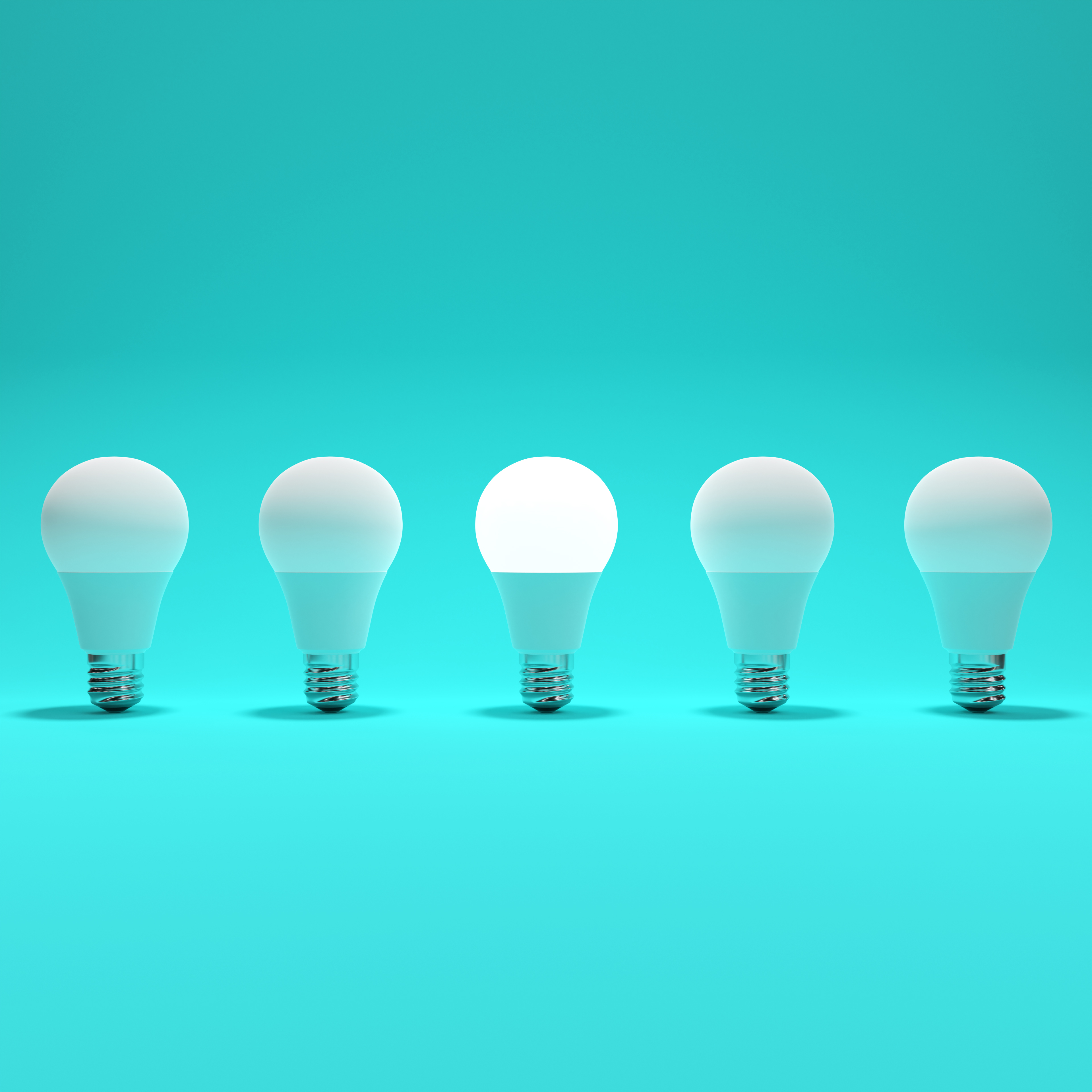 Five Lightbulb and One Glowing Lightbulb with Turqoise Background