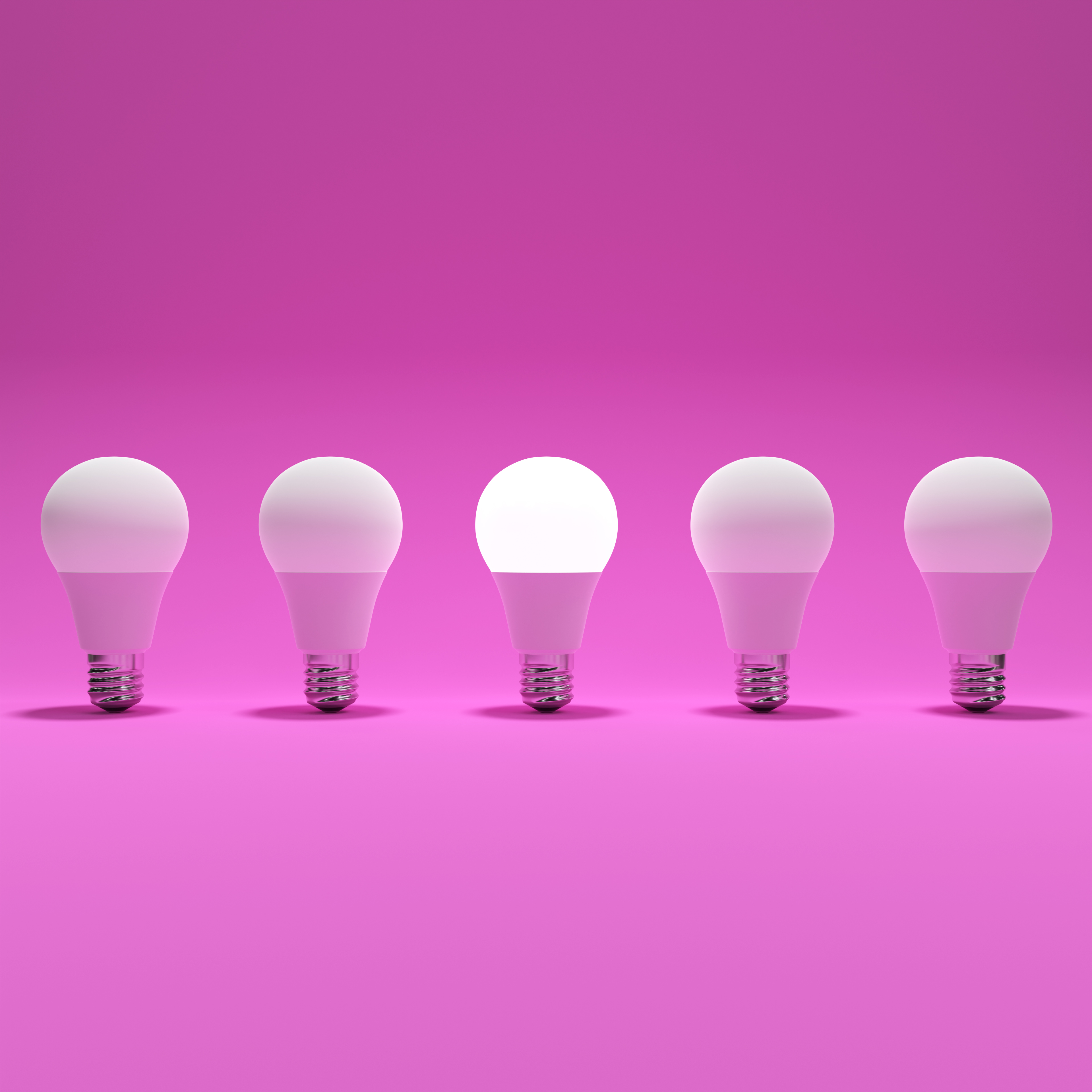 Five Lightbulb and One Glowing Lightbulb with Pink Background