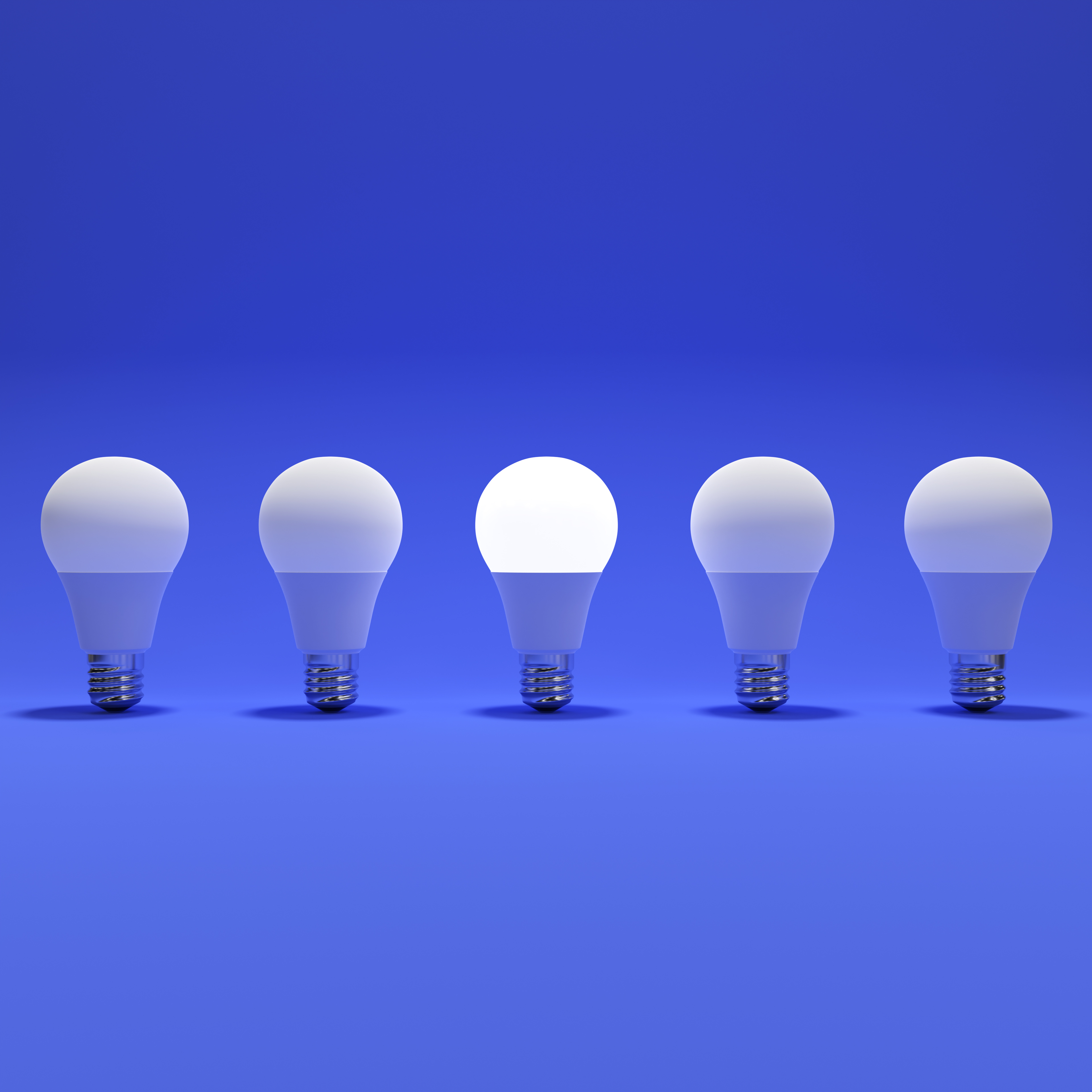 Five Lightbulb and One Glowing Lightbulb with Blue Background