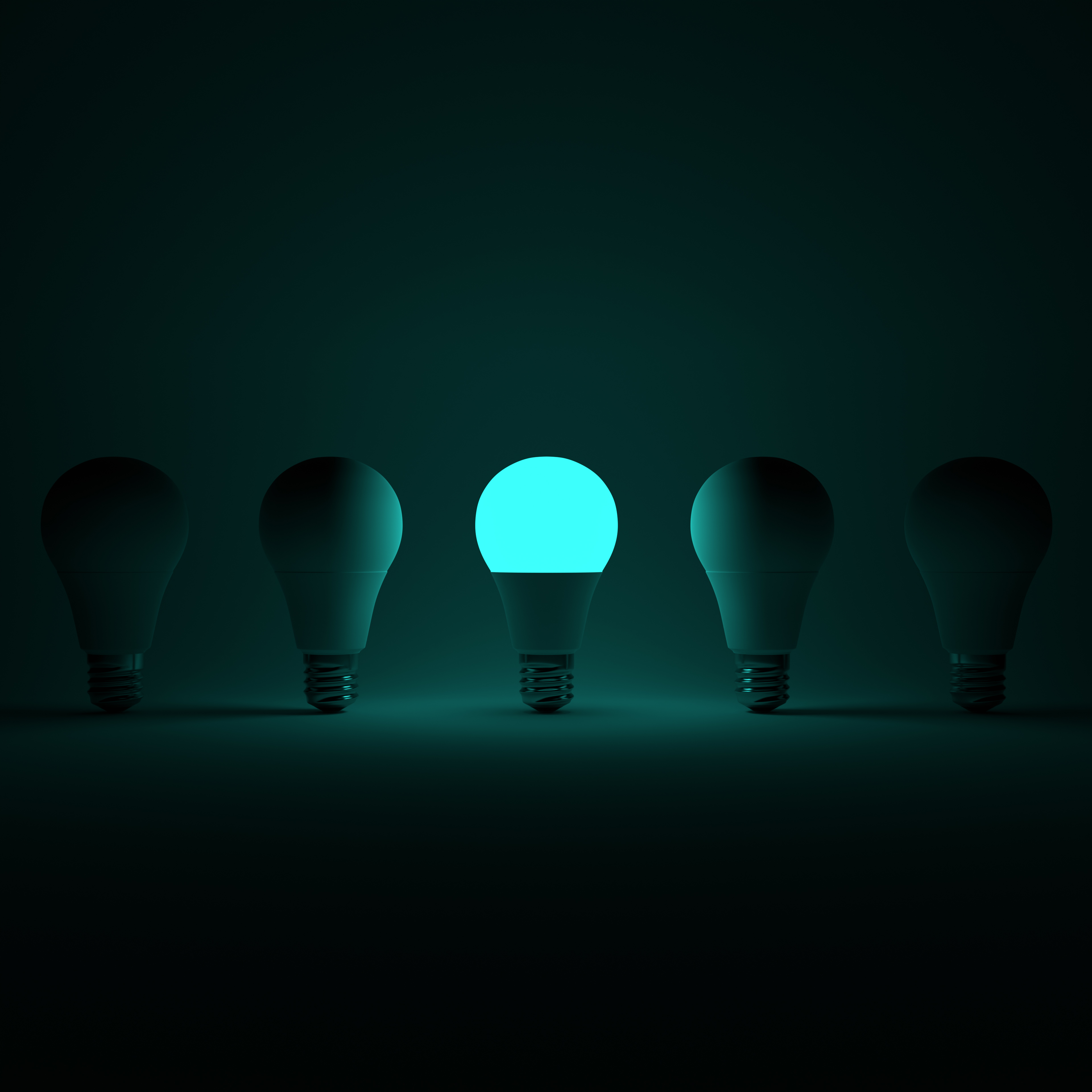Five Lightbulb and One Glowing Turqoise Lightbulb with White Background