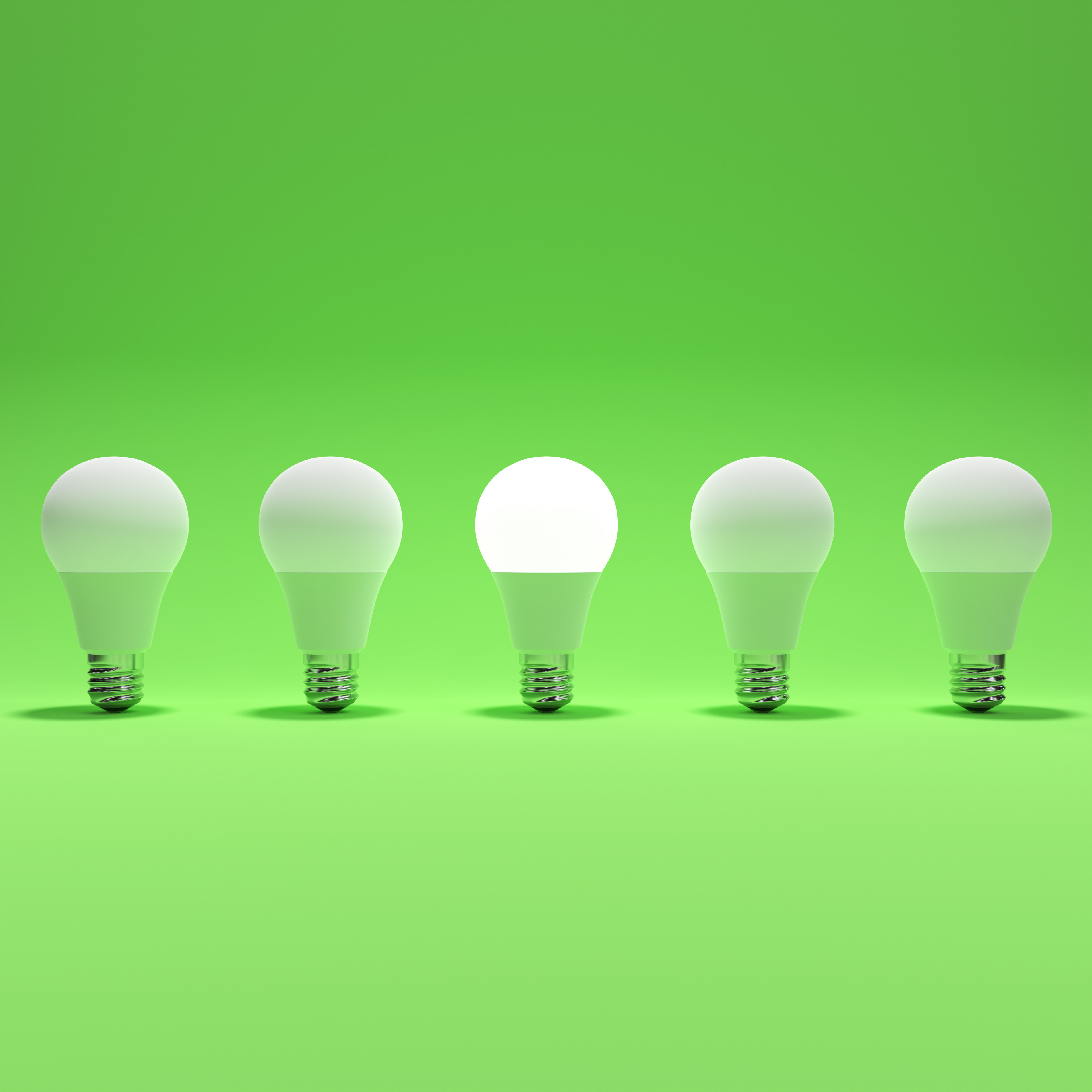 Five Lightbulb and One Glowing Lightbulb with Green Background