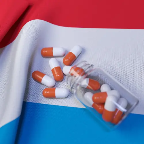 Pills and Capsules on Country Flags – Global Healthcare and Medicine Concept